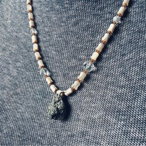 Necklace made with carved mother of pearl, hand cut crystal and fools gold